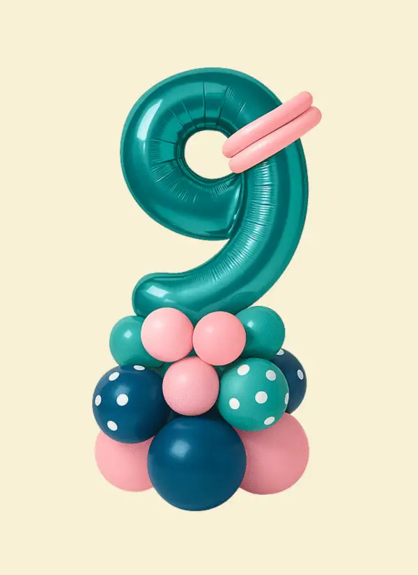 Small balloon marquee with a large foil number “9” in blush pink, surrounded by latex balloon clusters in Legacy Balloons’ brand colors and accented with Dalmatian print balloons.